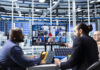 Businesspeople collaborating on sustainable energy investments during hybrid set up