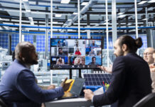 The Fed Shows Hybrid Work Has Stabilized, And The Data Explain Why Businesspeople collaborating on sustainable energy investments during hybrid set up