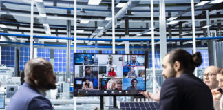 Businesspeople collaborating on sustainable energy investments during hybrid set up