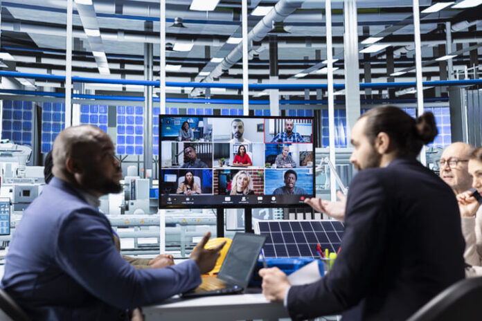 Businesspeople collaborating on sustainable energy investments during hybrid set up
