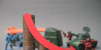 Red falling down red graph and stack coins with soldier fights, weapon war background. The global economic impact of the war, recession, energy crisis, oil price hike supply shortage and Effect of Iran war.
