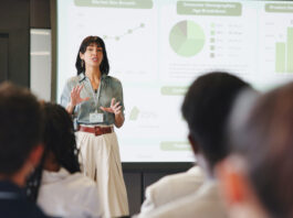 Financial Services Firms Spend Heavily on Events. Nobody Owns What Comes Out of Them. Presentation, screen and businesswoman in office for planning with finance graph, statistics or charts. Meeting, speech and female financial manager with information for investment pitch in workplace