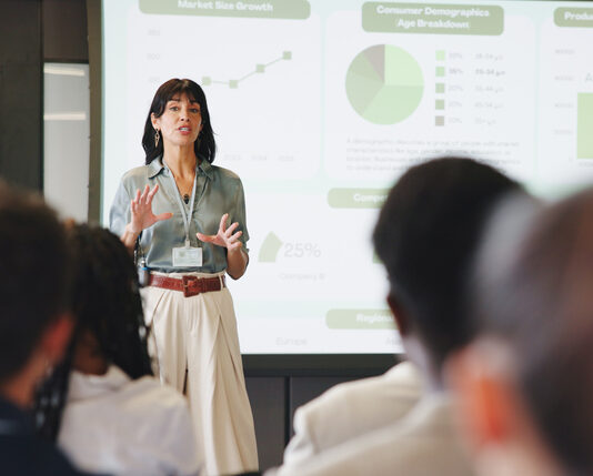 Presentation, screen and businesswoman in office for planning with finance graph, statistics or charts. Meeting, speech and female financial manager with information for investment pitch in workplace