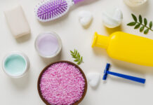 Cost of Hair Care Kits in India Explained Overhead view pink salt with cosmetics products white background