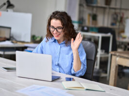 How A Major Hybrid Work Inquiry Should Change Washington Happy young business woman employee, hr manager having remote online work hybrid meeting or distance job interview waving hand looking at laptop during virtual video conference call in office.