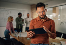 Founder Lessons: How to Step Back Without Stepping Away founder of business working using a tablet