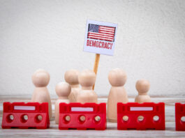 Autocratizing Democracies. A War Just For Power (Part 1) democracy = Sign with Red Barriers Representing Protest or Political Action.
