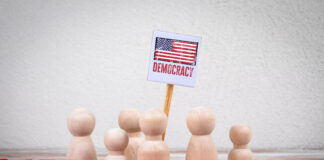 democracy = Sign with Red Barriers Representing Protest or Political Action.