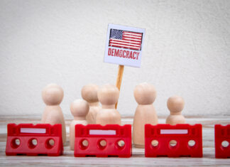 democracy = Sign with Red Barriers Representing Protest or Political Action.