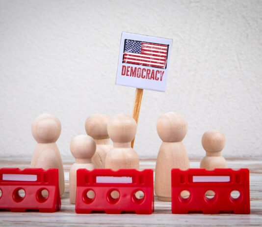 Autocratizing Democracies. A War Just For Power (Part 1) democracy = Sign with Red Barriers Representing Protest or Political Action.