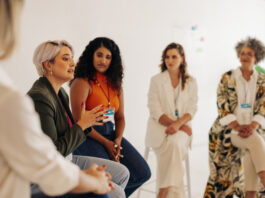 How Girl Hold My Hand Reflects Stormy Nicole Wellington’s Larger Mission Confident businesswomen having a discussion during a conference meeting. Group of multicultural businesswomen sharing ideas while working together in an all-female startup.