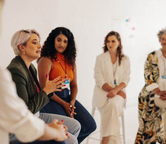 How Girl Hold My Hand Reflects Stormy Nicole Wellington’s Larger Mission Confident businesswomen having a discussion during a conference meeting. Group of multicultural businesswomen sharing ideas while working together in an all-female startup.