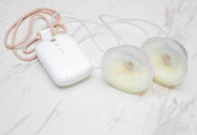 Smart Pumping: Digital Tracking for Modern Parents Smart pumping: Electric breast pump with milk collection cups on a white marble background.