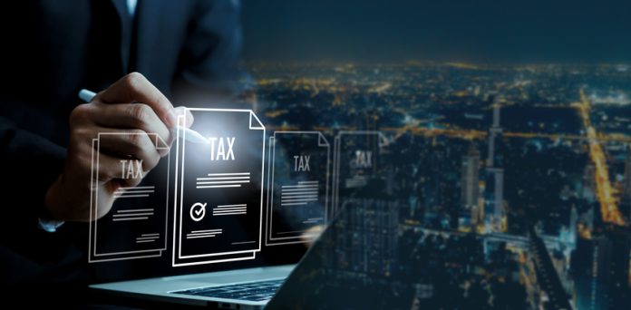 Business professional approving digital tax documents on laptop with stylus pen online filing system, financial compliance, e-tax technology smart city background corporate accounting workflow concept Tax Playbooks