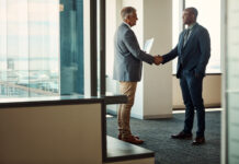 The Last Mile of Global Business Full length shot of two businessmen shaking hands in an office for global business