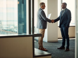The Last Mile of Global Business Full length shot of two businessmen shaking hands in an office for global business