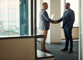 The Last Mile of Global Business Full length shot of two businessmen shaking hands in an office for global business