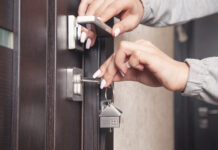 Composite Door Lock Problems, and Why They Differ From uPVC Woman hand holding Composite Door Lock key at home.