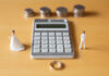 The Retirement Asset Most Divorcing Couples Undervalue Couple in troubles in connection with divorce, marriage and family. Retirement Asset. Concept of couple's money troubles with calculator and ring.