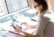 7 Signs Your Small Business Should Switch to Outsourced Bookkeeping Services Woman doing accounting for Outsourced Bookkeeping services