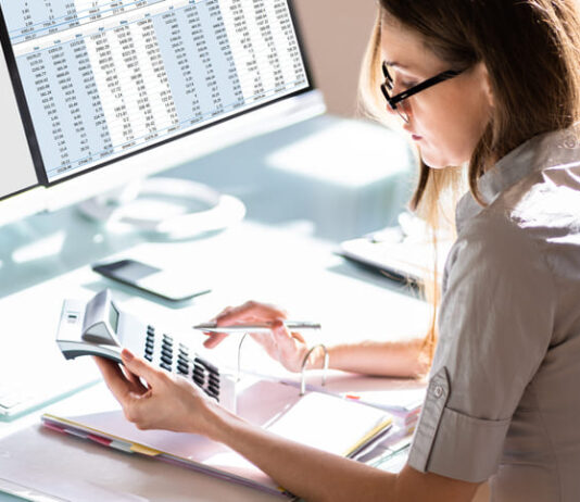 Woman doing accounting for Outsourced Bookkeeping services