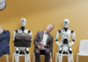 AI Job Disruption is Moving From Forecasts to Hiring Plans Tired exhausted applicants and android AI robot waiting for the job interview. AI Job Disruption concept