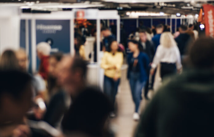 Abstract blurred people at exhibition hall of expo event trade show. Business convention show or job fair. Business concept background. Global Trade Shows