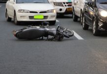 Personal Accident Cover in Bike Insurance: Is It Mandatory? Personal Accident Cover - motorcycle lying on the road