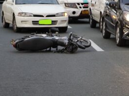 Personal Accident Cover in Bike Insurance: Is It Mandatory? Personal Accident Cover - motorcycle lying on the road