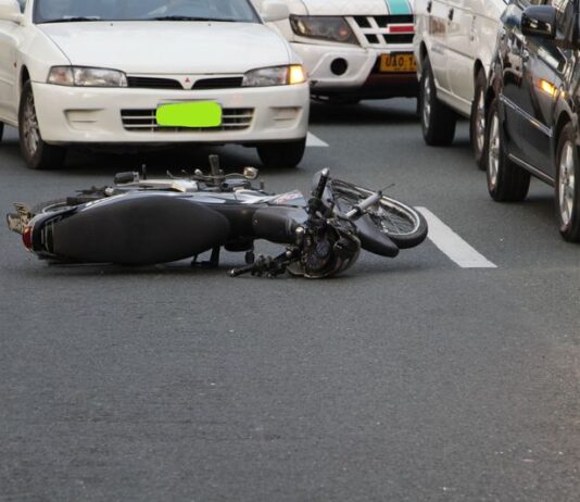 Personal Accident Cover in Bike Insurance: Is It Mandatory? Personal Accident Cover - motorcycle lying on the road