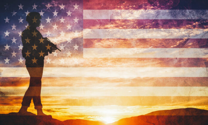 iStock-1007144846 (1) Armed soldier with rifle and USA flag. Guard, army, military, war.