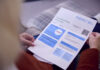 Strategies UK Businesses are Adopting to Lower Energy Bills Close Up Of Senior Woman At Home Looking At Energy Bill During Cost Of Living Energy Crisis