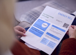 Close Up Of Senior Woman At Home Looking At Energy Bill During Cost Of Living Energy Crisis