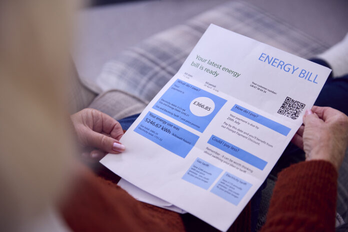 Close Up Of Senior Woman At Home Looking At Energy Bill During Cost Of Living Energy Crisis