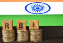 A closeup selective focus picture of a letters of RBI Repo Rate against the background of Indian Flag