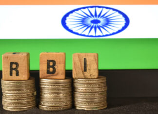 How RBI Repo Rate Changes Flow Through to Your MSME Loan Interest A closeup selective focus picture of a letters of RBI Repo Rate against the background of Indian Flag