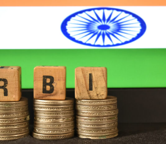 How RBI Repo Rate Changes Flow Through to Your MSME Loan Interest A closeup selective focus picture of a letters of RBI Repo Rate against the background of Indian Flag