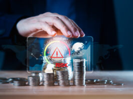 From Perceived Risk to Bankable Investment: Closing Africa’s Financing Gap Business man using hand to protect a stack of coins with a red warning sign for risk management. Concept of business or financial risks. Africa’s Financing Gap concept
