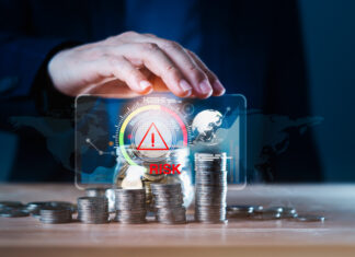 Business man using hand to protect a stack of coins with a red warning sign for risk management. Concept of business or financial risks. Africa’s Financing Gap concept