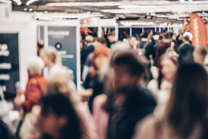 Abstract blurred people at exhibition hall of expo event trade show. Business convention show or job fair. Business concept background. Forex Expo Dubai 2026