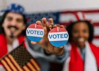 voting in the U.S., wearing American flag caps and showing happiness and civic pride while watching the elections.