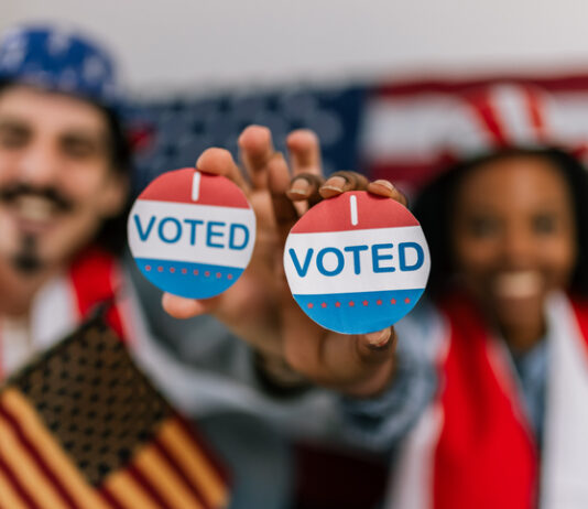 voting in the U.S., wearing American flag caps and showing happiness and civic pride while watching the elections.