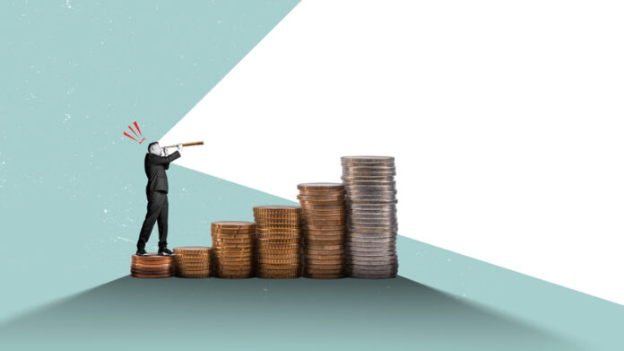 A businessman examines economic growth opportunities with a telescope.